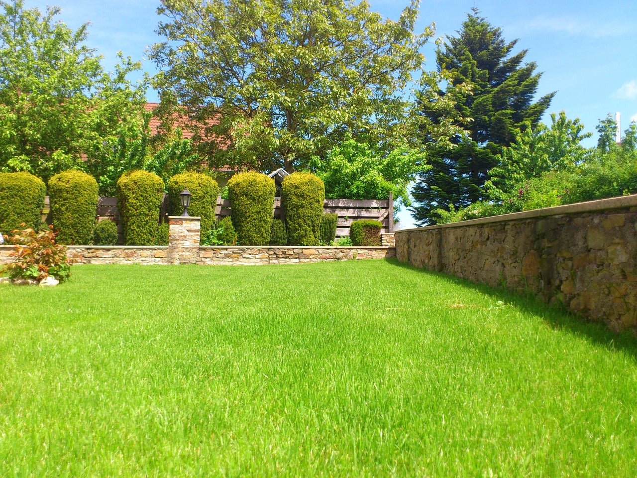 What is a front groomer on a lawn mower and what benefit does it provide?